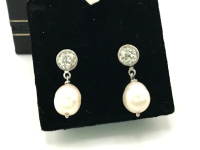A pair of diamond earrings with pearls. Diamonds approximately 0.30ct each and 22mm overall length.