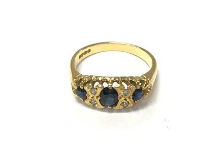 An 18ct gold sapphire and diamond set ring. 
Size L 1/2 and 3.84g