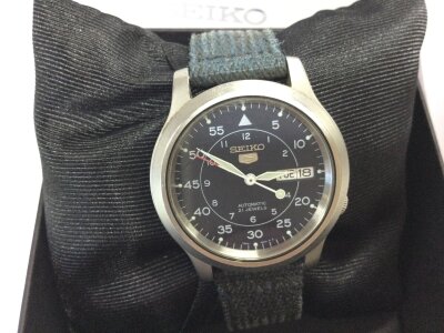 A Seiko 5 sports watch. Blue dial and blue canvas strap. Comes with box.