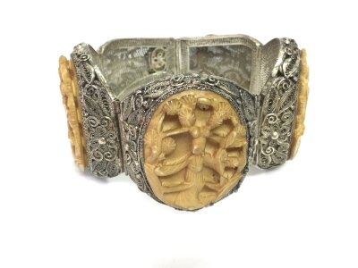 An interesting silver Chinese filigree bracelet with panels carved from bone depicting a woman among plants.