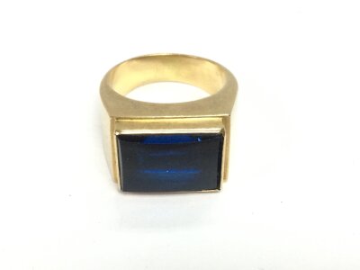 A gold gents ring set with a large sapphire (possibly heat treated) size S and 13.69g