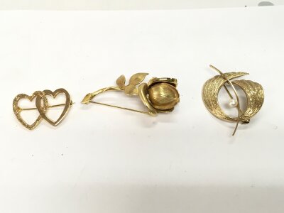 Three 9ct gold brooches of assorted designs.
16.35g