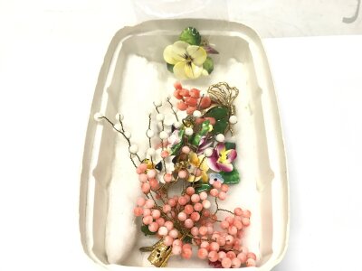 A box of jade, coral brooches, ceramic brooches etc
