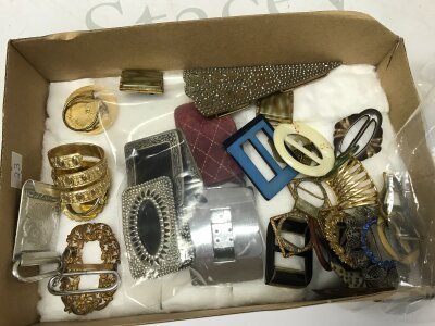 A collection of vintage buckles and scarf clips