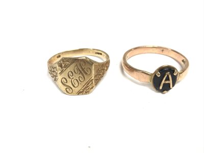 Two 9ct gold rings. A gents ring and an A initial ring. Sizes T and V 7.12g total.