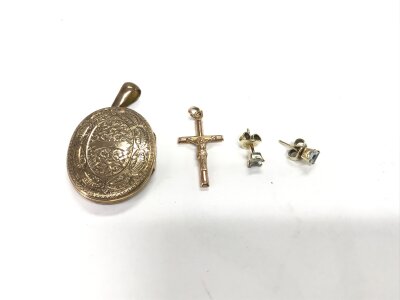 9ct gold crucifix a gold front and back locket and a pair of aquamarine studs.
