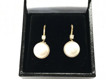 A pair of 9ct gold earrings with suspended round white cultured pearls and diamonds to the bales.