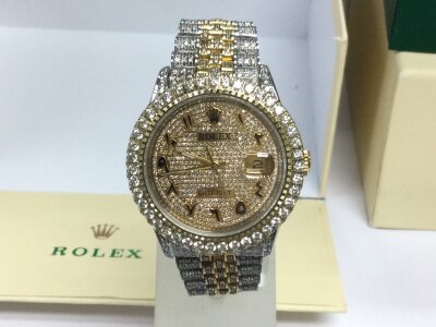 A Rolex Datejust model 16233 which has been ‘iced out’ steel and gold jubilee strap with full diamond gold dial also diamond bezel and case and strap. Comes with box but no paperwork. Seen running.