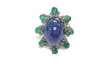 Silver dress ring with Large oval cabochon tanzanite surrounded by pear shaped emeralds and diamonds. Size P 1/2