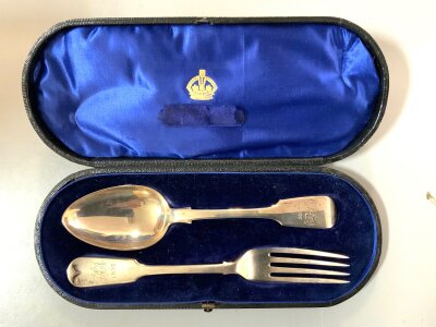 A cased hallmarked silver spoon and fork set with engraved monogram and date 1897, London 1840.