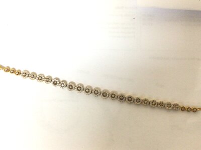 A high grade gold bracelet with graduating circular links set with diamonds marked 916. Weight 11.4g