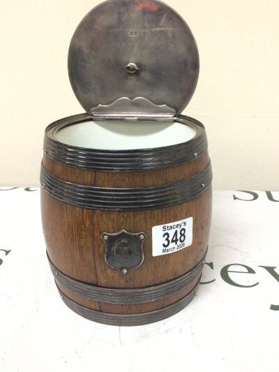 A Silver mounted oak biscuit barrel with a ceramic liner.