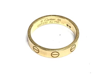 A Cartier 18ct gold ring with paperwork and packaging. Size K and 3.13g
