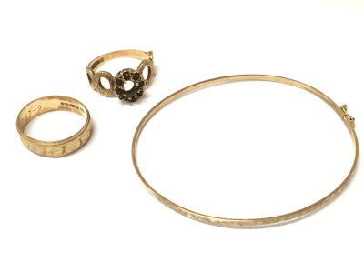 Two 9ct gold rings and a 9ct gold bangle. 8.4g total weight
