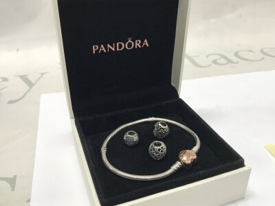 A boxed Pandora bracelet and charms