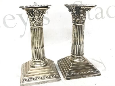 A pair of Corinthian column candlesticks, 15cm tall. Marked London 1893