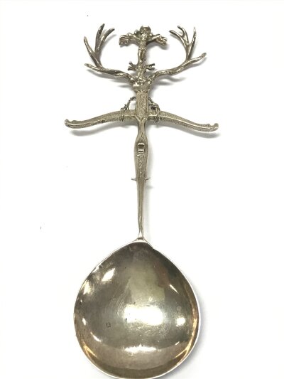 An unusual Scottish silver spoon, the design features a crossbow, a crucifix and stag. Approximately 70g .18cm long