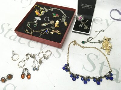 A small box of costume jewellery including some silver earrings,