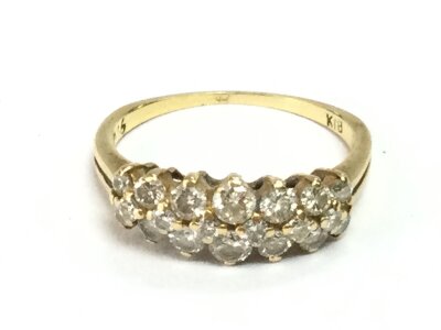 An 18ct gold ring set with two rows of diamonds. Size L 1/2 and 2.74g