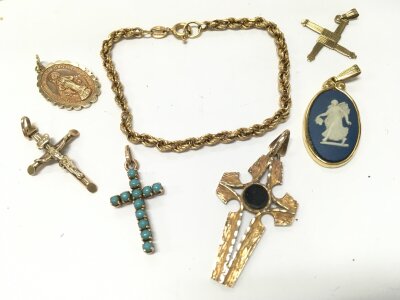 A mixed collection of gold and gold mounted pendants. 14.3G total weight