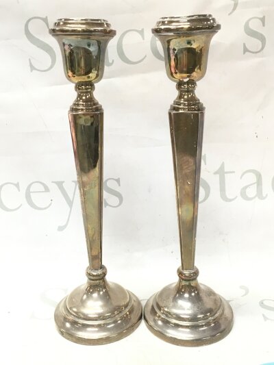 A pair of silver candle sticks loaded base, 31cm tall