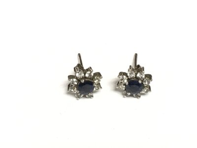 A pair of white metal earrings set with sapphire and diamonds, approx 1.5g.