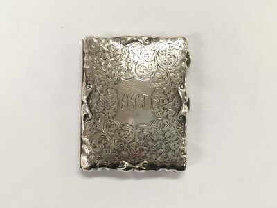 A silver card case with foliate decoration, Birmingham 1908, approx 72.6g.