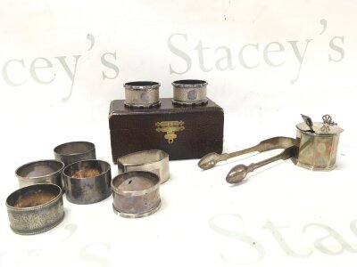 A Collection of silver hallmarked napkin rings, a pair of tongs and a mustard pot. 390g total silver weight