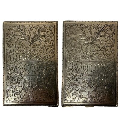 A heavy .800 silver engraved cigarette case with engraved floral decoration. 12cm x 7.8cm, 130g.