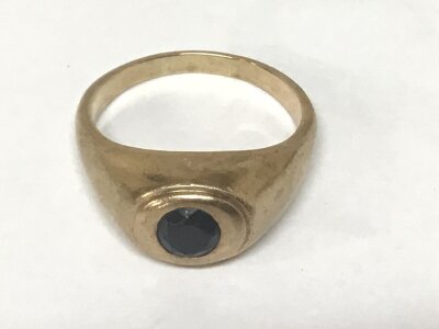 An unmarked gold ring (9carat) set with a dark sapphire. Weight 8g