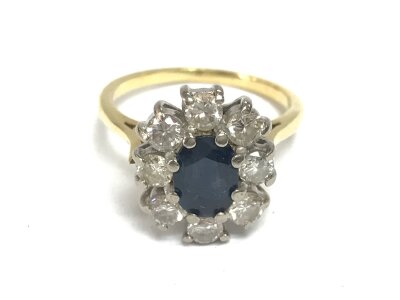 An 18ct gold (unmarked) sapphire and diamond cluster ring. Size J and 3.86g