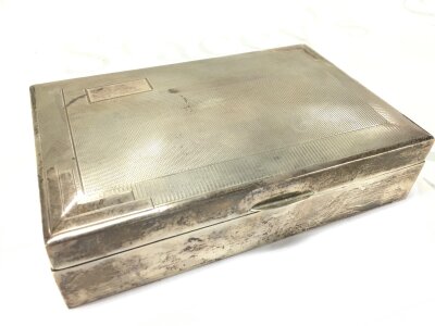 A hallmarked silver cigarette box. 17cm wide 5cm tall 11cm deep