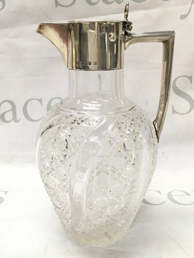 A hallmarked silver mounted cut glass jug 25cm tall