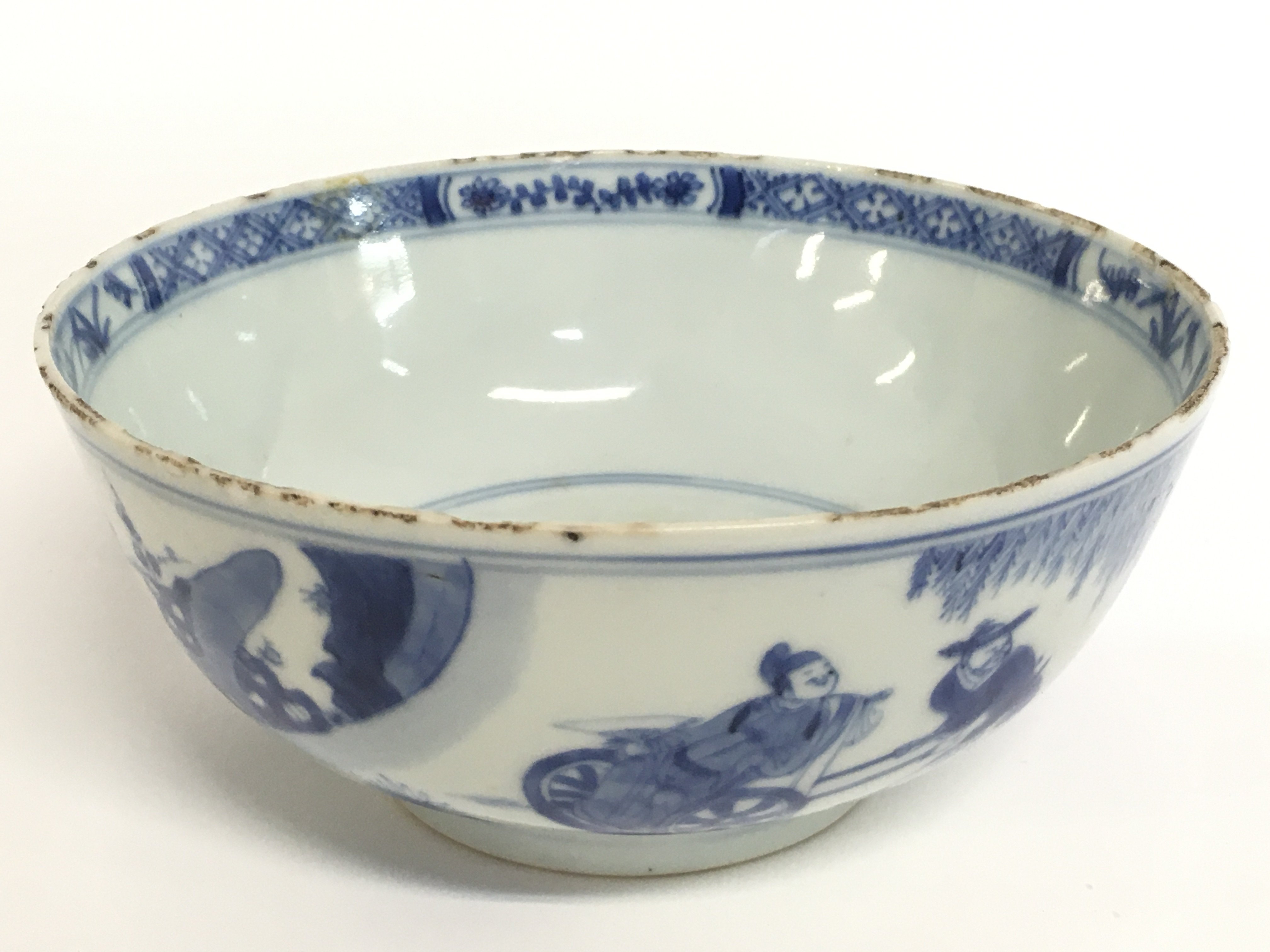 An early 18th century Chinese blue and white bowl decorated with figures with garden view .15 cm width height 6.5 cm . Hairline crack seen on the inside of the bowl. This item comes under postage category D meaning it cannot be posted.