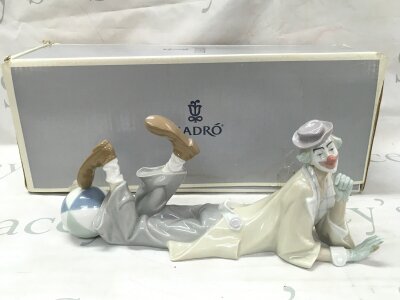 A boxed Lladro laying clown figure, 38cm long. No obvious damage or restoration