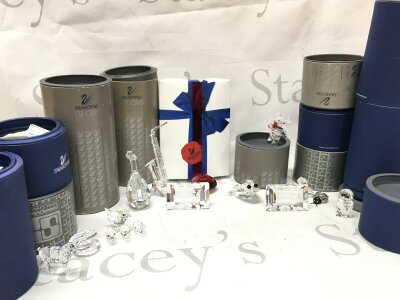 A collection of boxed Swarovski figures, animals, magnets, flowers etc