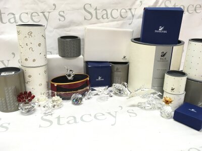 A collection of boxed Swarovski figures including animals , musical instruments