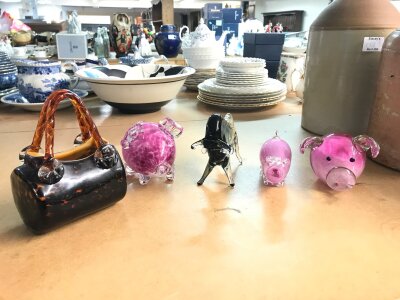 A Collection of glass animals including pigs and a bull and a glass handbag