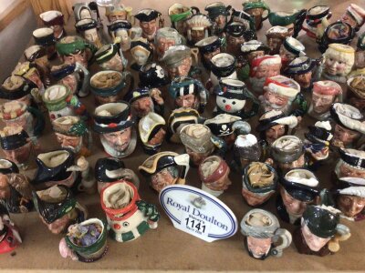 A large collection of Royal Doulton Miniature and small caricature jugs no obvious damage or restoration and a Royal Doulton plaque. over 100 caricature jugs.