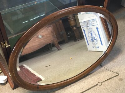 An oval wall mirror.75cm wide- NO RESERVE