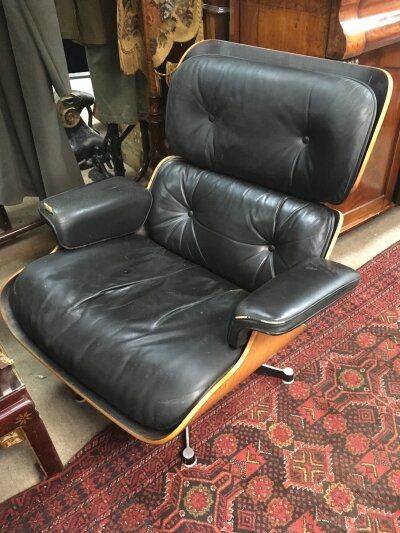 Charles Eames Lounge Chair and Ottoman (Models 670 and 671), Herman Miller label for a Charles Eames-designed piece of furniture, specifically manufactured under license by Hille of London Ltd. Signs of wear. Circa 1960s.