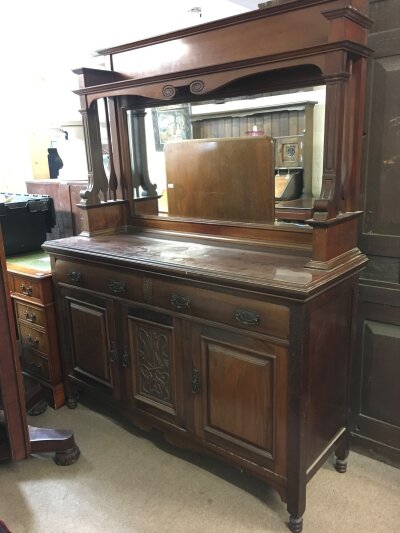 An Edwardian large walnut sideboard with mirrored back, dimensions 150cm wide , 194cm tall , 54cm long