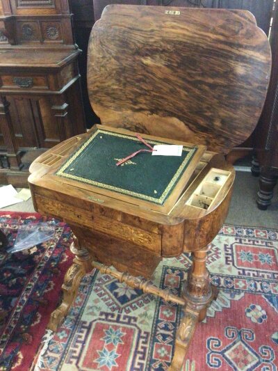 A quality Victorian burr walnut inlaid workbox with hinged shaped top enclosing leather lined writing slope above a drawer and sliding wool box compartment