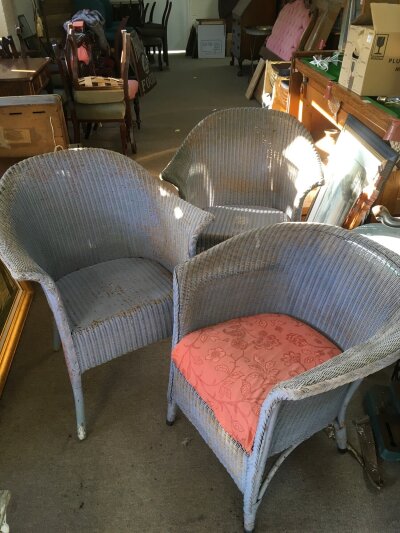 Three Lloyd Loom chairs.