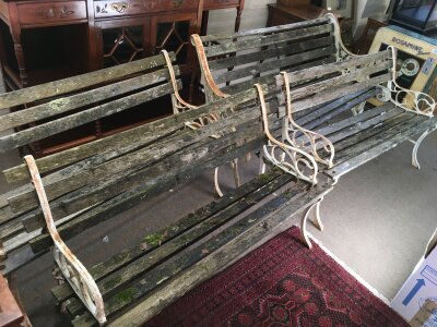Four garden benches with cast iron ends.