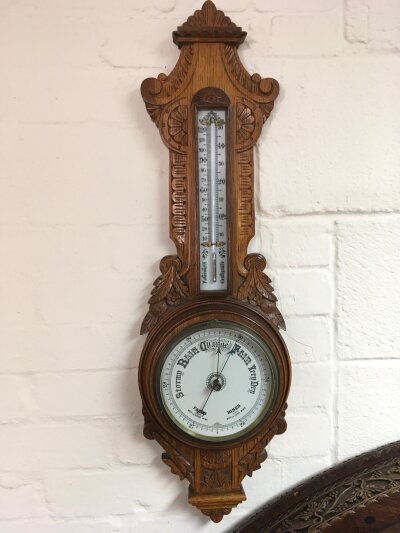 A oak carved barometer.