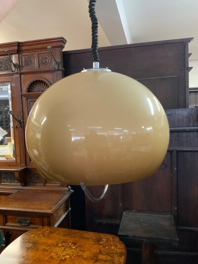 A vintage "Jumbo" or "Big Bud" pendant light designed by Harvey Guzzini for Melbo, featuring a large beige/caramel acrylic globe shade and a retractable cord. (Unmarked) no damage.