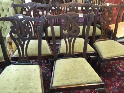 A set of six George III style dining chairs with open scroll backs and drop in seats on cabriole legs.