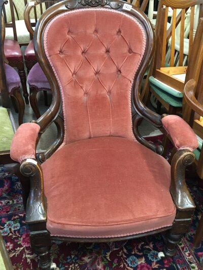 A Victorian mahogany open arm chair with a shaped back scroll arms and tapering legs.
