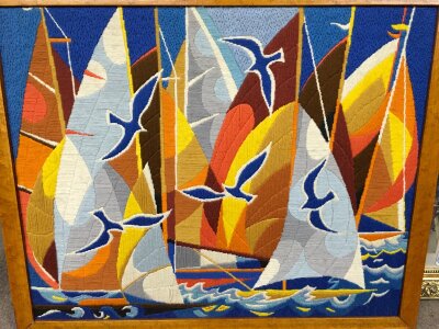 A framed Simon Chaye tapestry depicting  sailing Schooner. 72cm x 87cm including frame